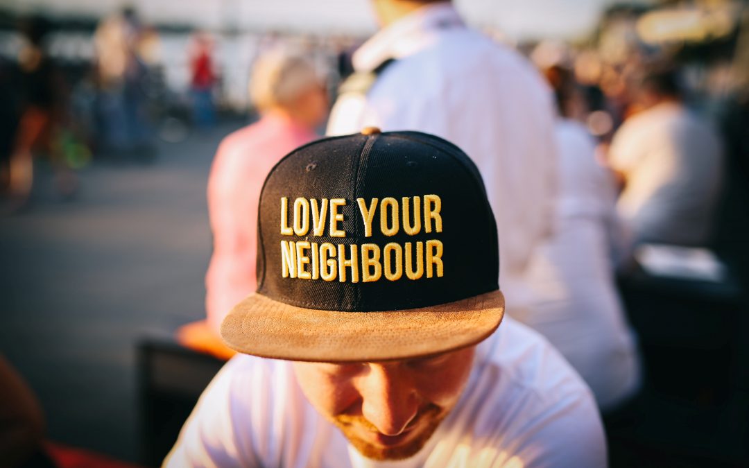 Mean wearing baseball cap which says Love Your Neighbour