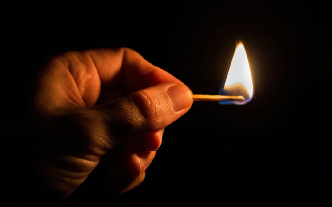 Hand holding a match