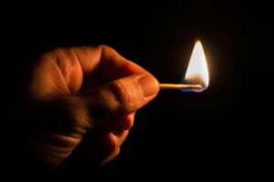 Hand holding a match