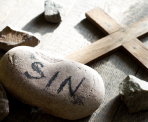 The word sin written on a stone