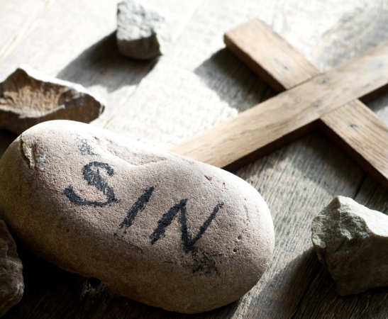 The word sin written on a stone